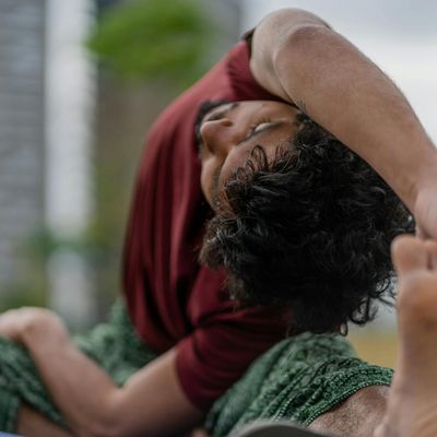 Person in a deep stretching pose after a workout.